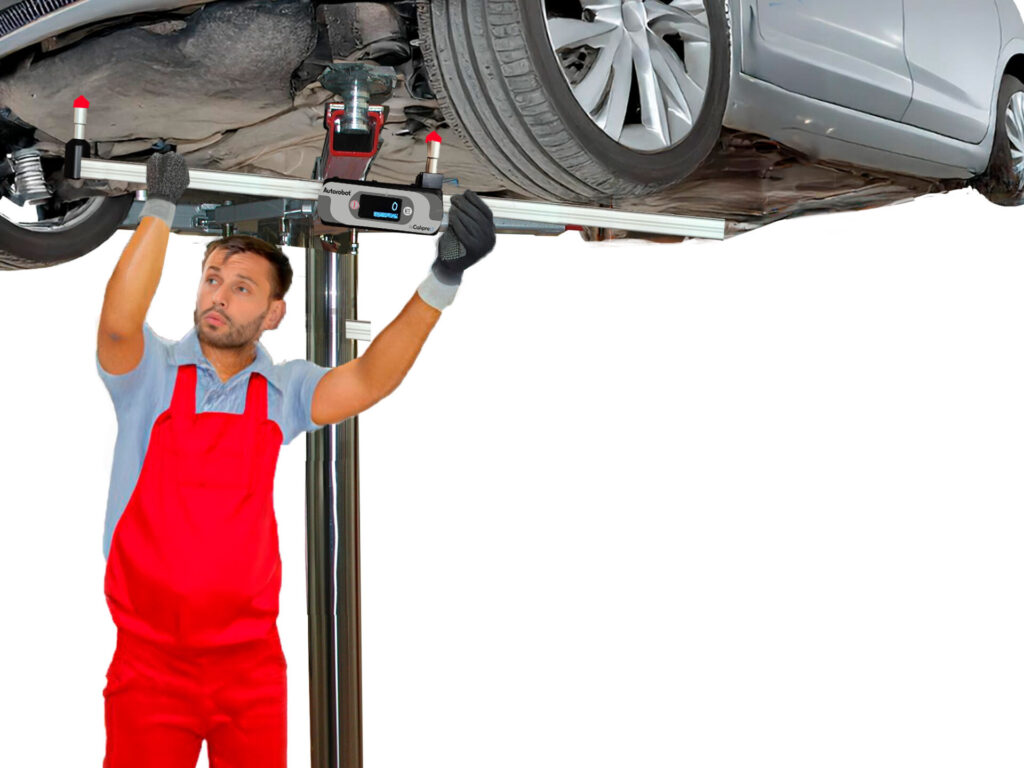 A man measuring a car’s underbody with a measuring tram bar.